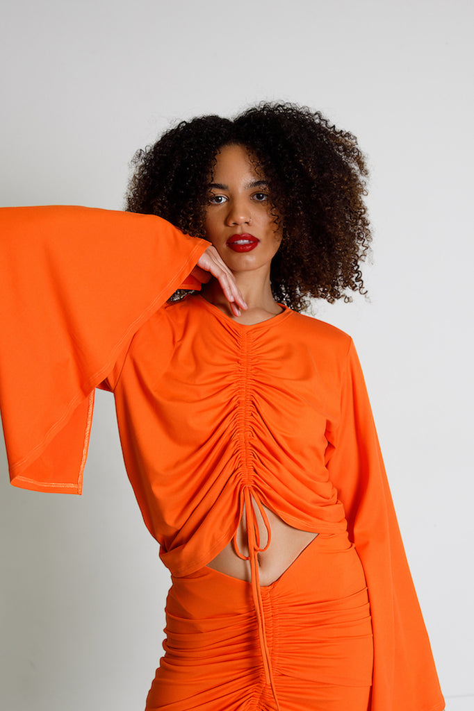 Orange exaggerated bell sleeve shirt with drawcord